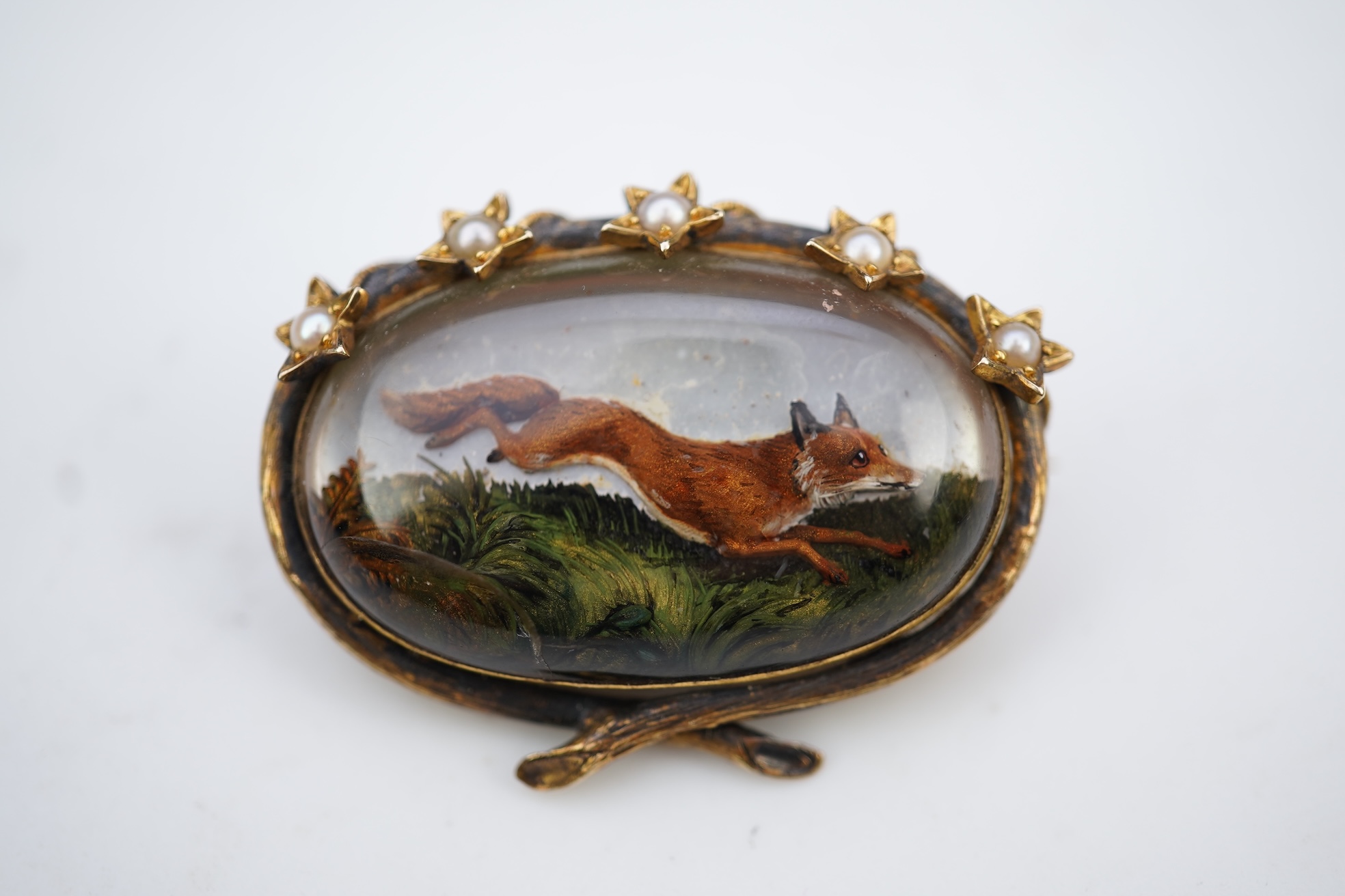 A reverse-carved and painted intaglio 'Essex crystal' brooch, late 19th century